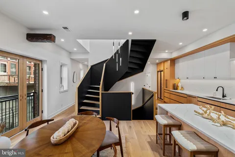 a living room with wooden floor and furniture