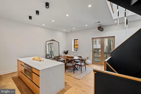 a kitchen with a sink a stove and cabinets