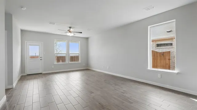 a view of kitchen with wooden floor and electronic appliances