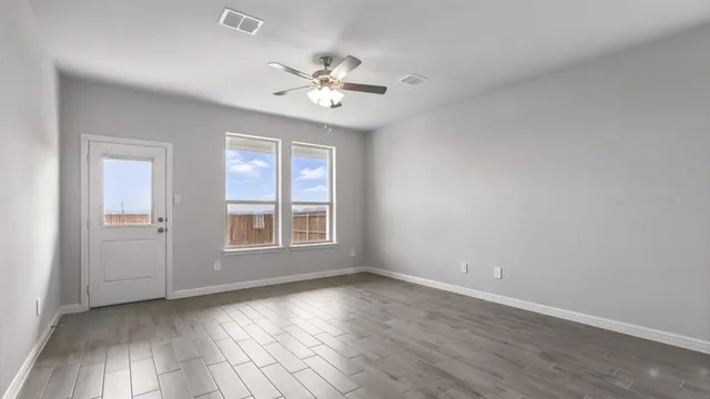 wooden floor in an empty room with a window