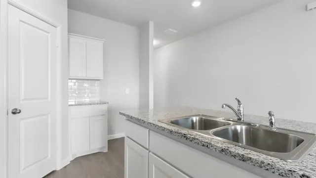 a kitchen with appliances a sink a counter space and cabinets