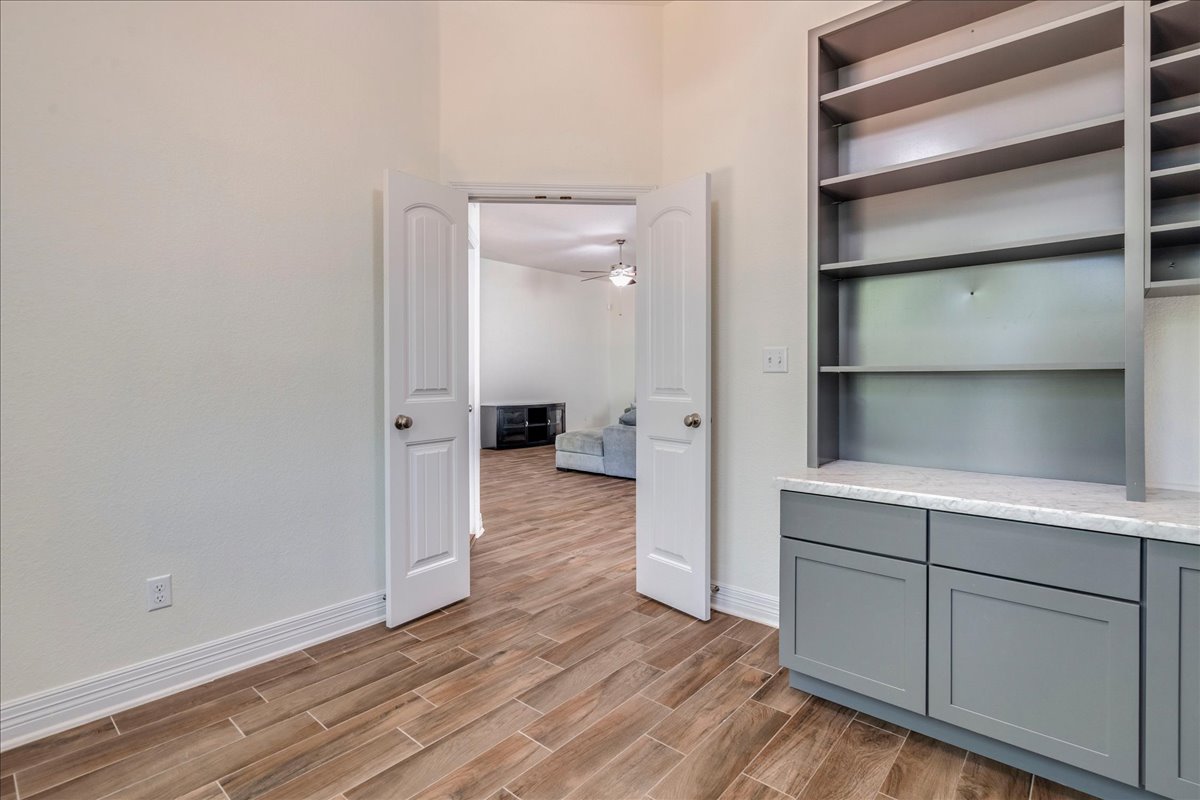 5009 Inks Clearing Lane Austin, TX 78738 - Photo 27 of 34 Double doors open to reveal versatile living areas accented by durable tile flooring.