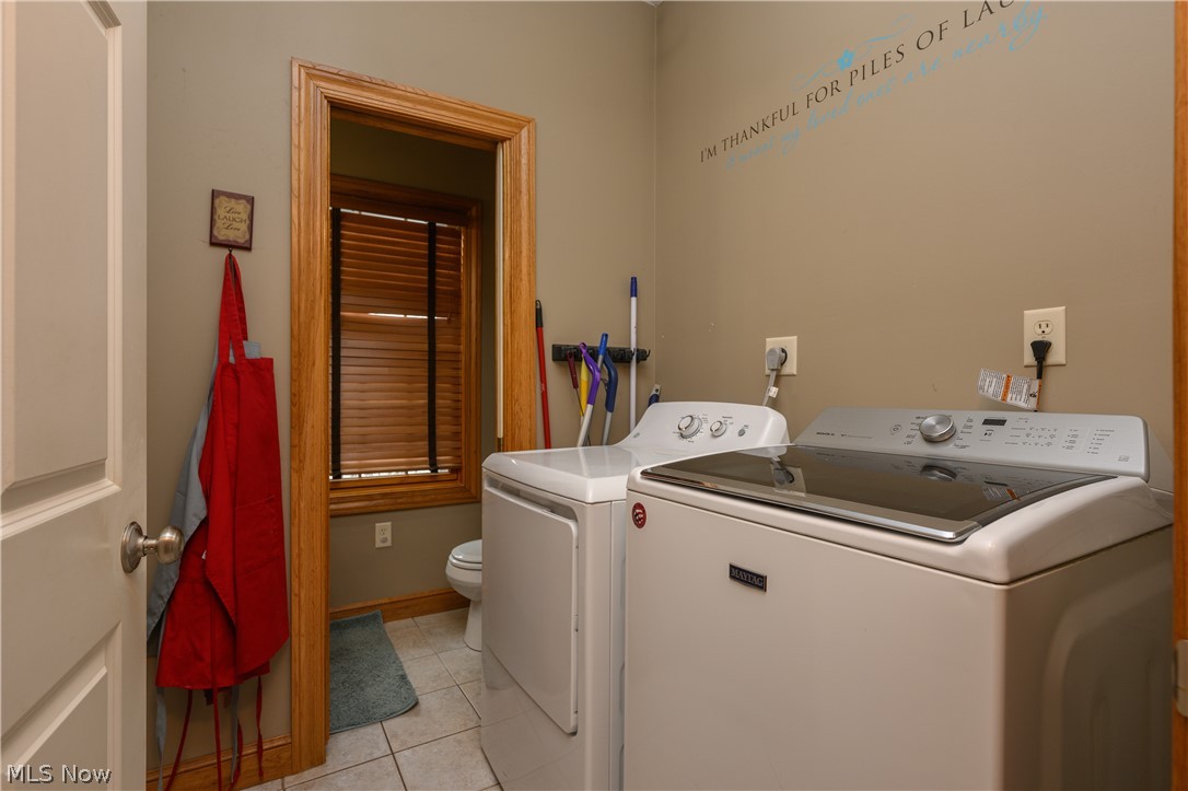 806 Forrest Ridge Drive Dover, OH 44622 - Photo 18 of 36 Laundry area featuring independent washer and dryer and light tile patterned flooring