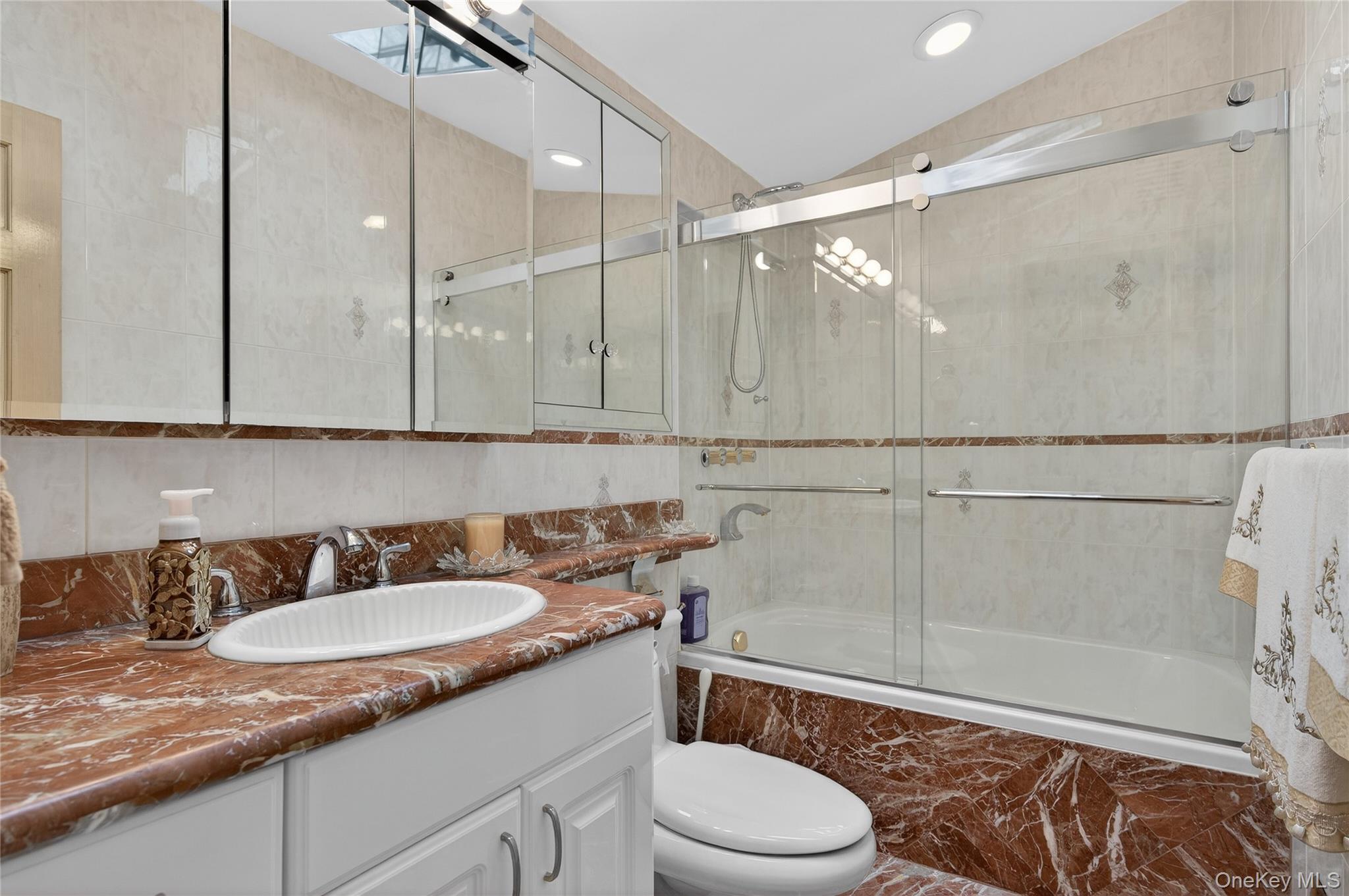 43 Highwood Road East Norwich, NY 11732 - Photo 15 of 32 a bathroom with a granite countertop sink toilet and shower