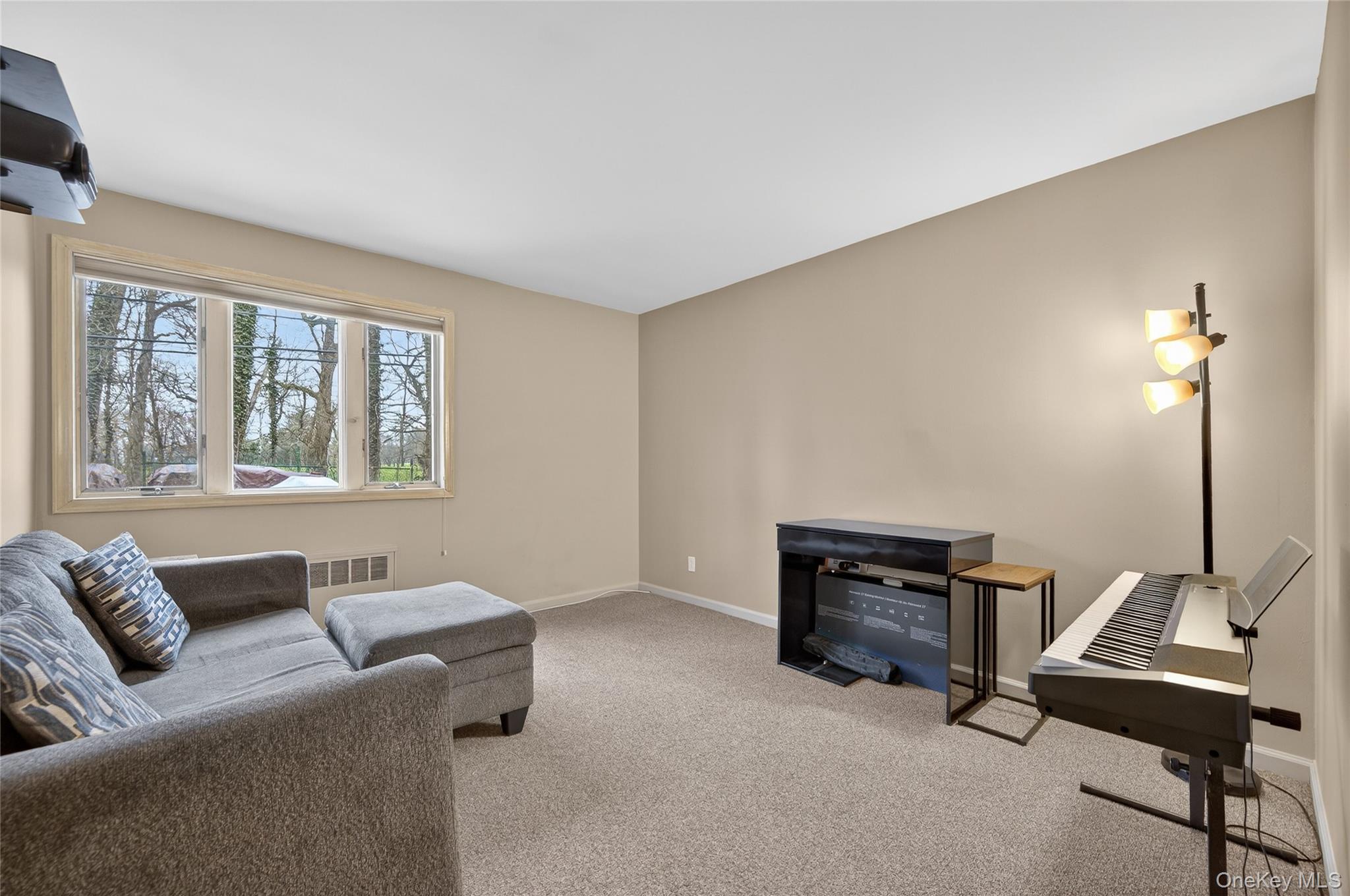 43 Highwood Road East Norwich, NY 11732 - Photo 20 of 32 a living room with furniture and a window
