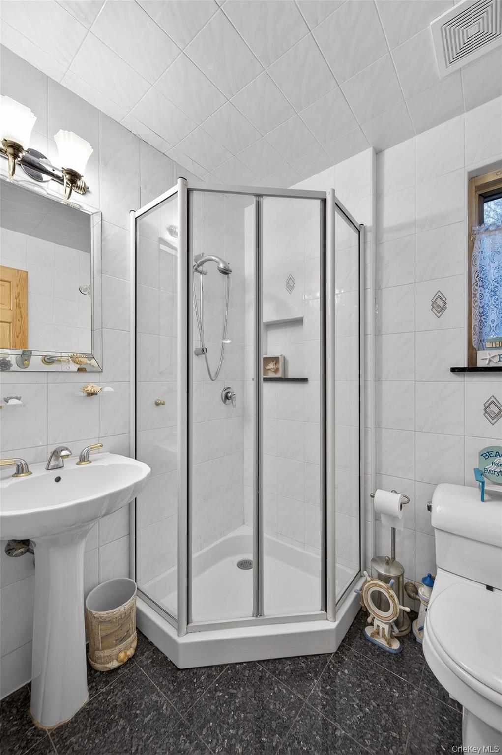 43 Highwood Road East Norwich, NY 11732 - Photo 21 of 32 a bathroom with a sink mirror toilet and shower