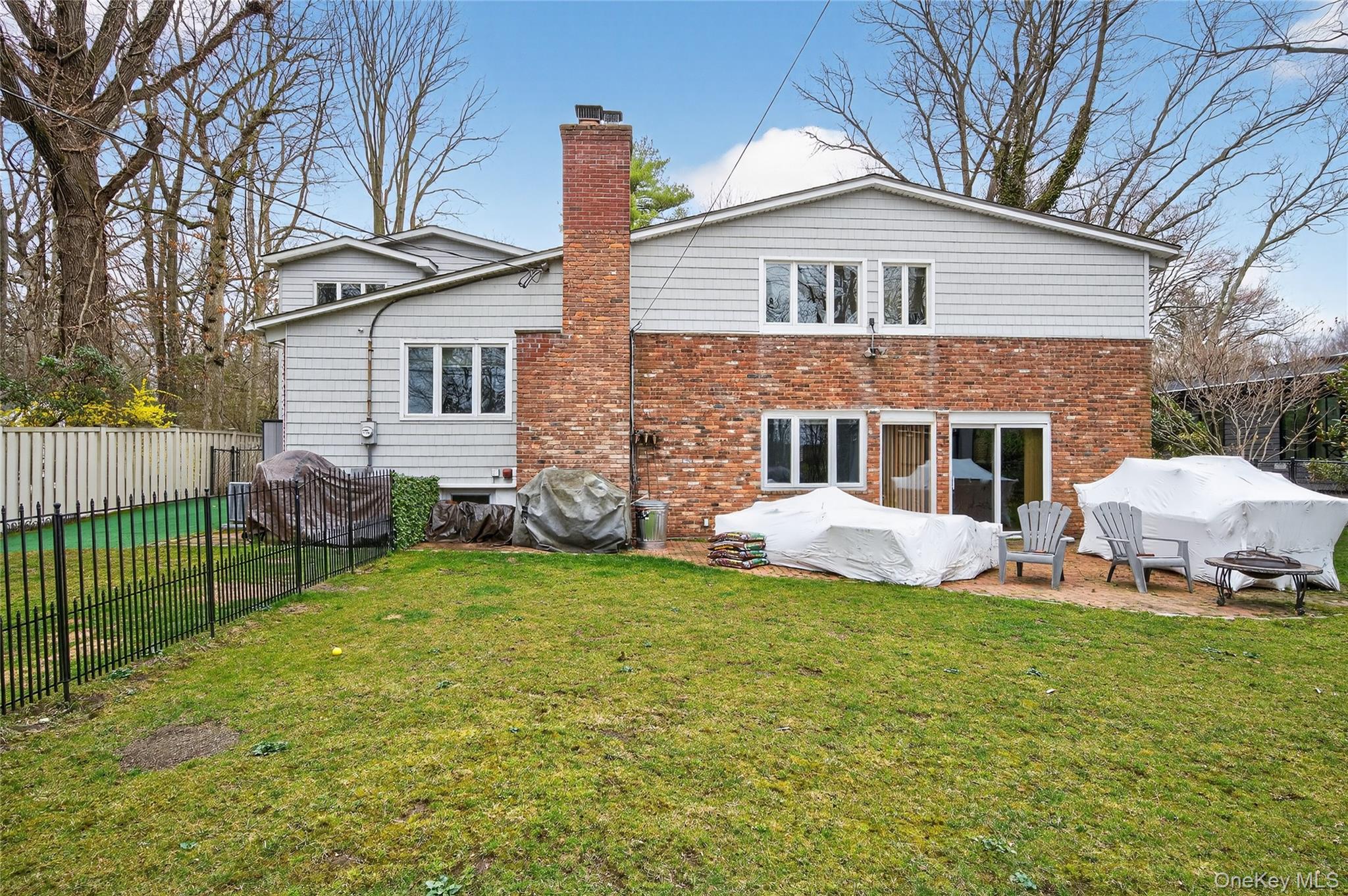 43 Highwood Road East Norwich, NY 11732 - Photo 22 of 32 a front view of a house with a yard and porch