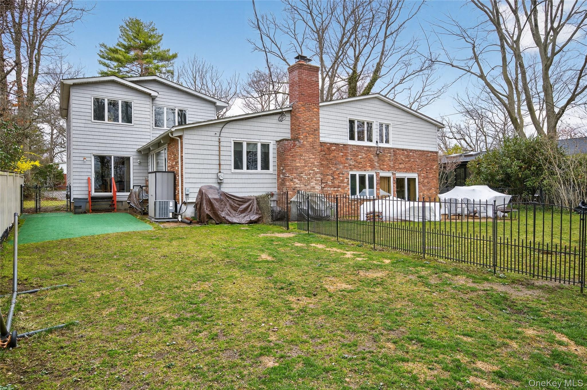43 Highwood Road East Norwich, NY 11732 - Photo 23 of 32 a view of a house with a yard and sitting area