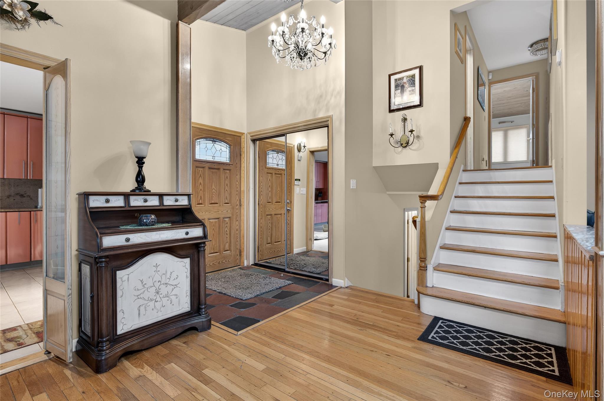 43 Highwood Road East Norwich, NY 11732 - Photo 3 of 32 a view of a livingroom with wooden floor and stairs
