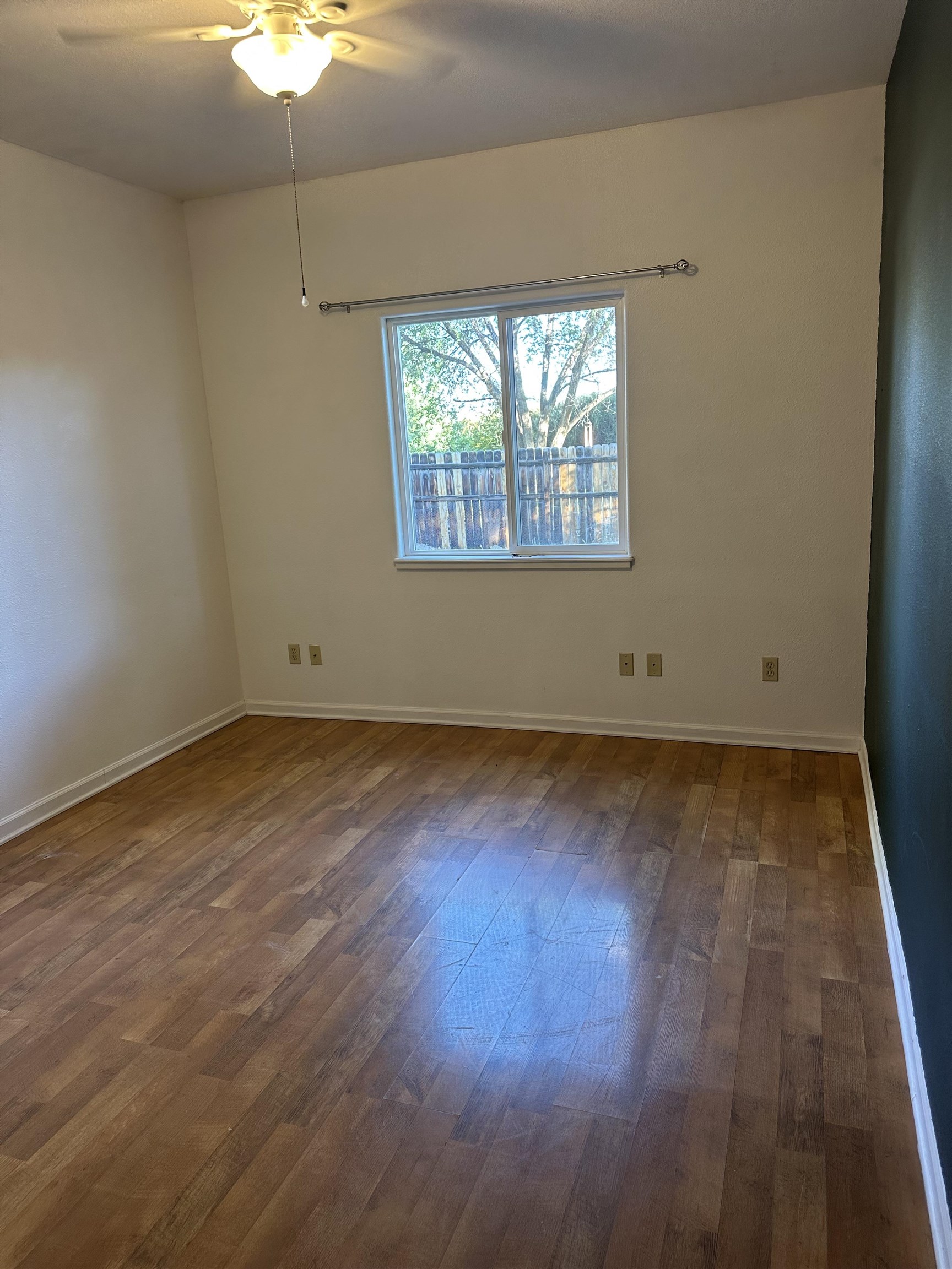 2678 Cambridge Road Grand Junction, CO 81506 - Photo 29 of 32 an empty room with wooden floor and windows