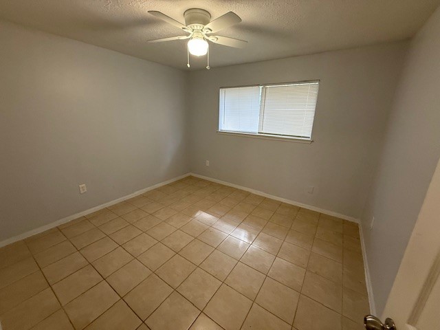 1610 Hazelwood Street, Unit A Conroe, TX 77301 - Photo 8 of 10 an empty room with windows