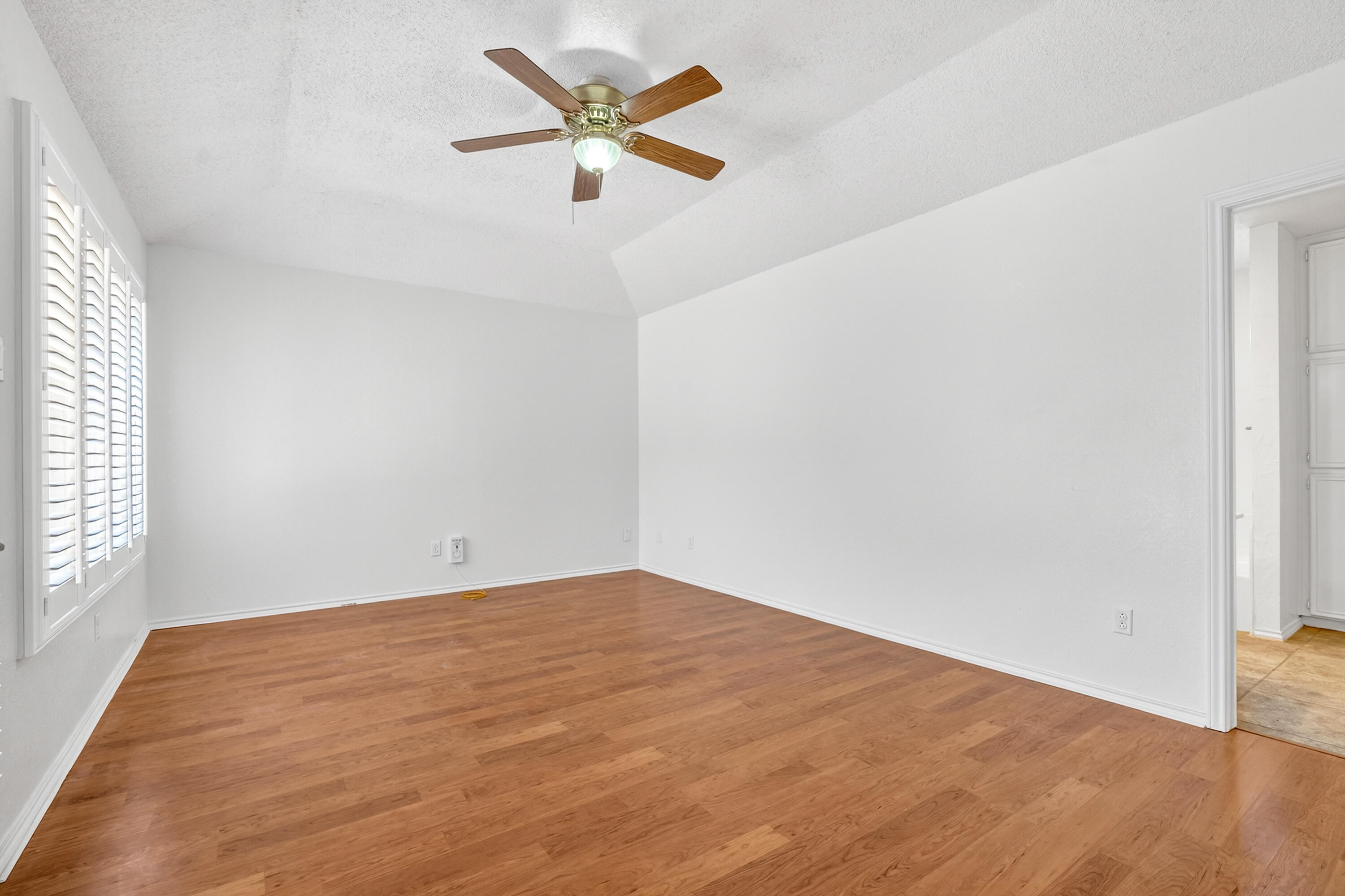 5221 84th Street Lubbock, TX 79424 - Photo 14 of 26 an empty room with a window and a fan