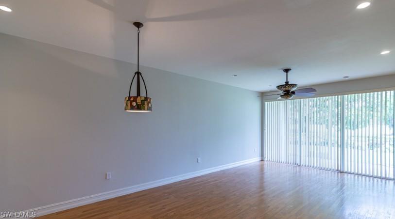 9113 Michael Circle, Unit 9 Naples, FL 34113 - Photo 15 of 28 a view of a room with wooden floor ceiling fan