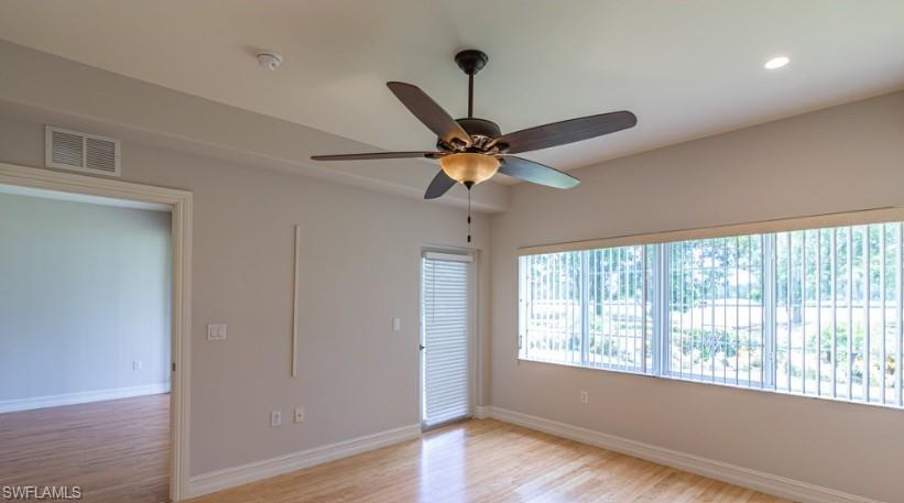 9113 Michael Circle, Unit 9 Naples, FL 34113 - Photo 20 of 28 a a room with a window and wooden floor