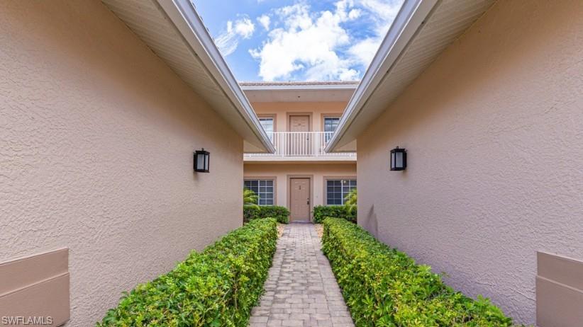 9113 Michael Circle, Unit 9 Naples, FL 34113 - Photo 2 of 28 a view of entryway in front of house