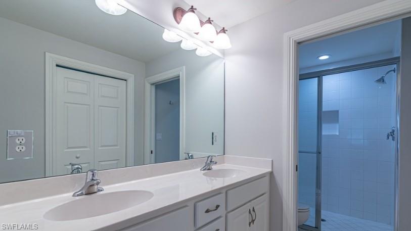 9113 Michael Circle, Unit 9 Naples, FL 34113 - Photo 22 of 28 a bathroom with a sink double vanity and a mirror