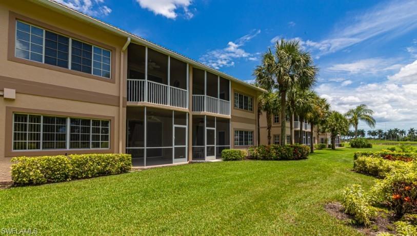 9113 Michael Circle, Unit 9 Naples, FL 34113 - Photo 26 of 28 a front view of a house with a yard