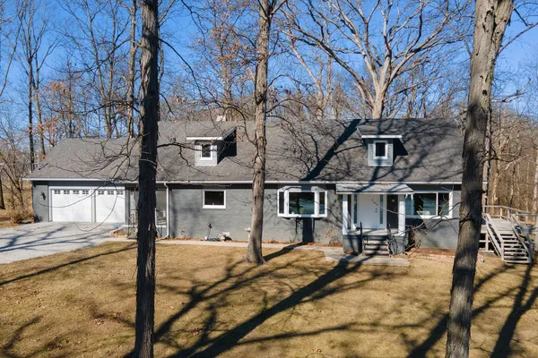 a view of a house with snow on the road
