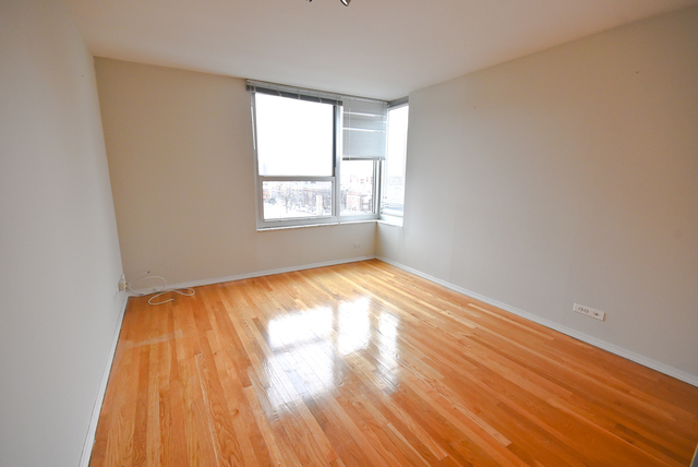 720 West Gordon Terrace, Unit 8L Chicago, IL 60613 - Photo 15 of 15 an empty room with wooden floor and windows
