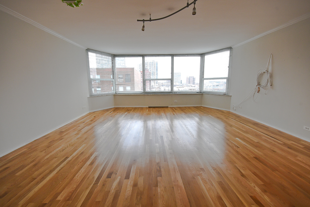 720 West Gordon Terrace, Unit 8L Chicago, IL 60613 - Photo 5 of 15 wooden floor in an empty room with a window
