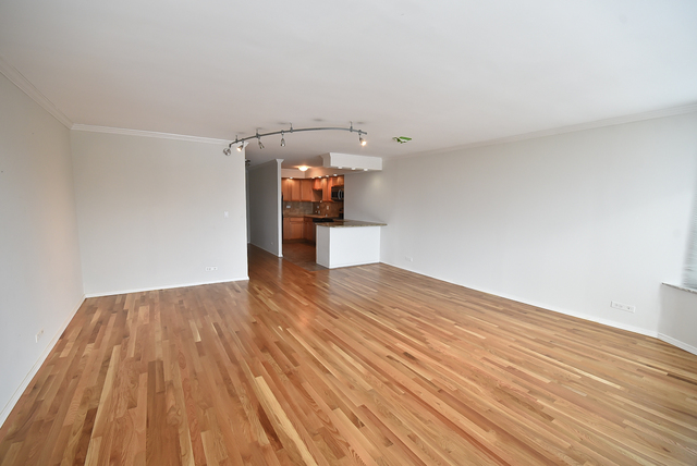 720 West Gordon Terrace, Unit 8L Chicago, IL 60613 - Photo 6 of 15 a view of empty room with wooden floor