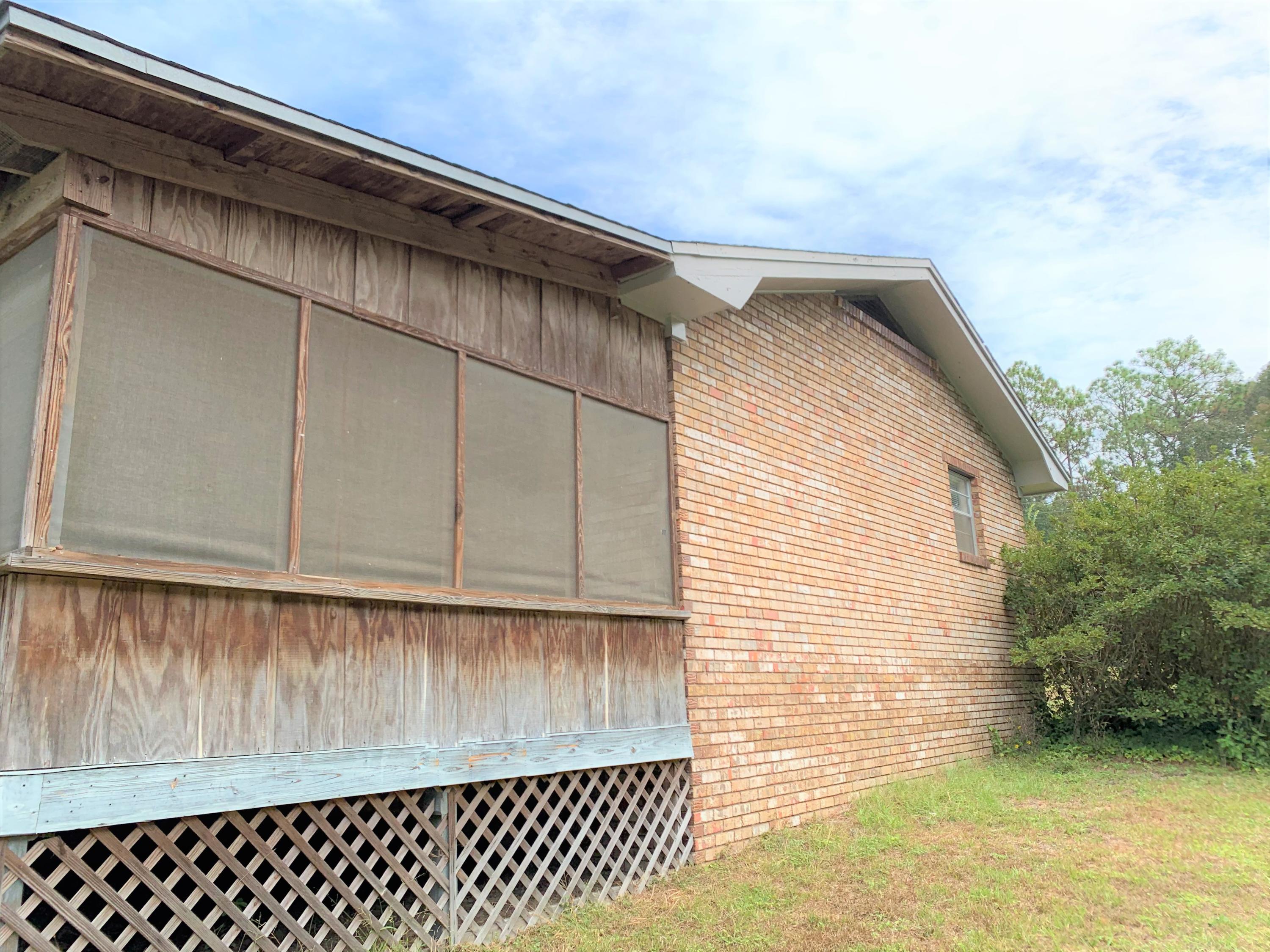 6084 Old Hickory Road Crestview, FL 32539 - Photo 22 of 27 a view of a house with a wooden fence