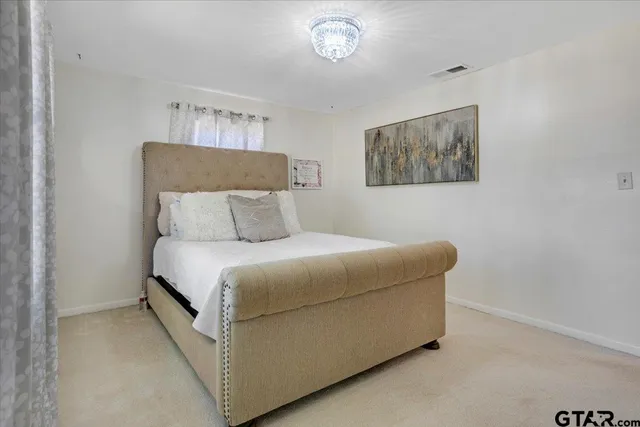 a bedroom with a bed and a lamp