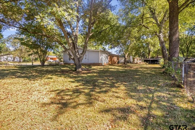 a view of a yard with a tree