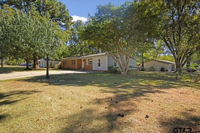 a view of house with yard