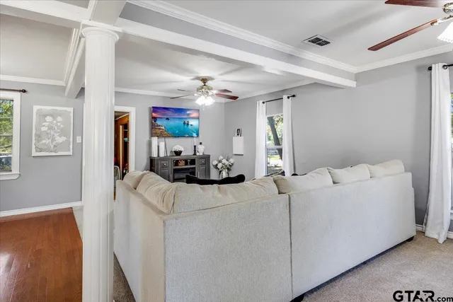 a living room with furniture and a flat screen tv