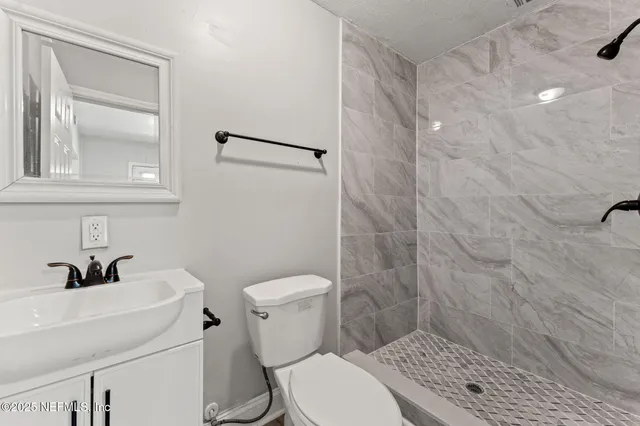 a bathroom with a sink toilet and shower