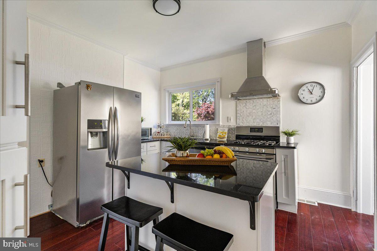 28 Jefferson Road Princeton, NJ 08540 - Photo 11 of 25 a kitchen with stainless steel appliances a stove a refrigerator a sink and a table with wooden floor