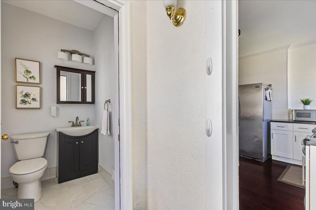 28 Jefferson Road Princeton, NJ 08540 - Photo 14 of 25 a bathroom with a toilet sink and mirror