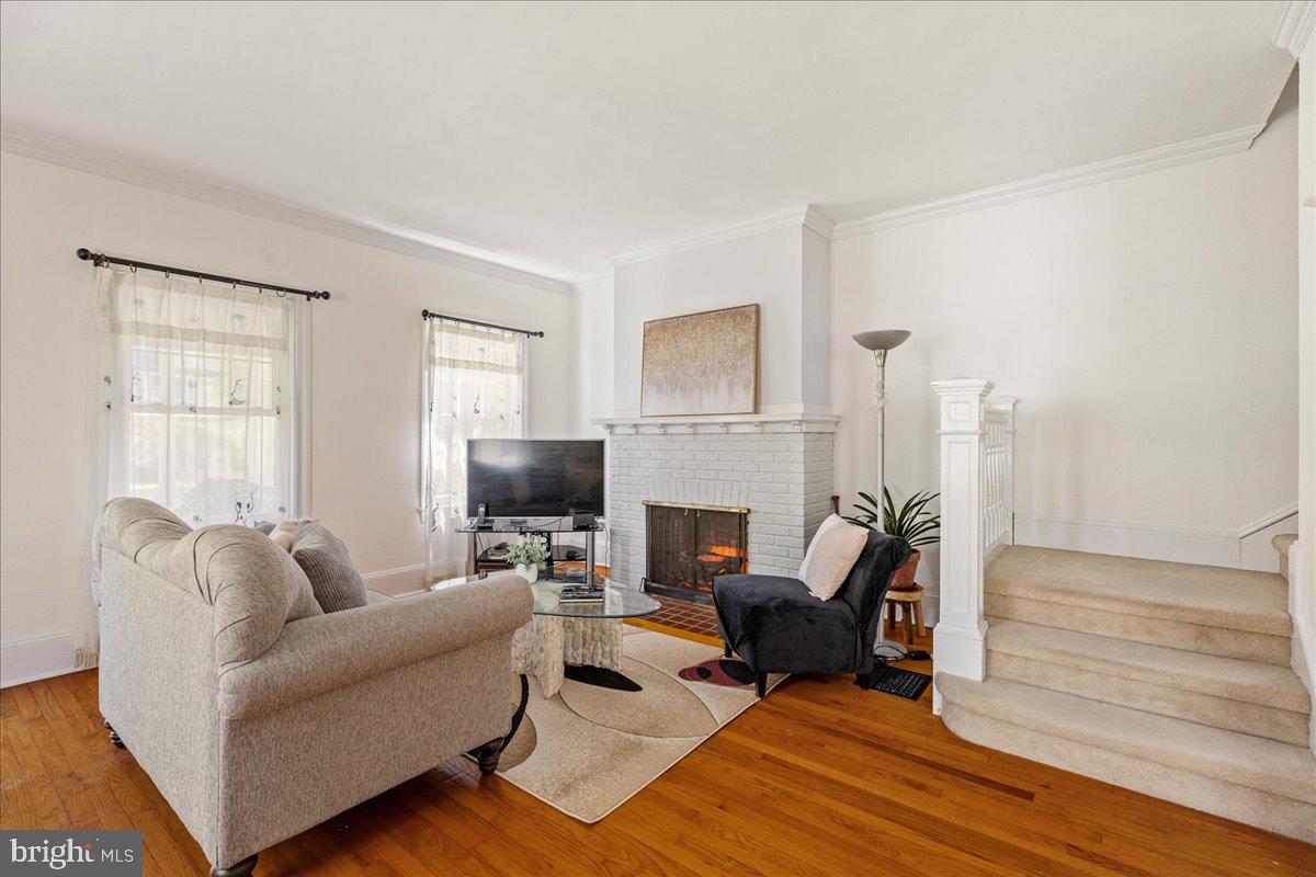 28 Jefferson Road Princeton, NJ 08540 - Photo 8 of 25 a living room with furniture a fireplace and a wooden floor