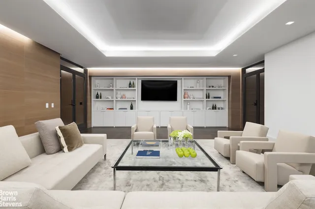 a view of a room with furniture and wooden floor