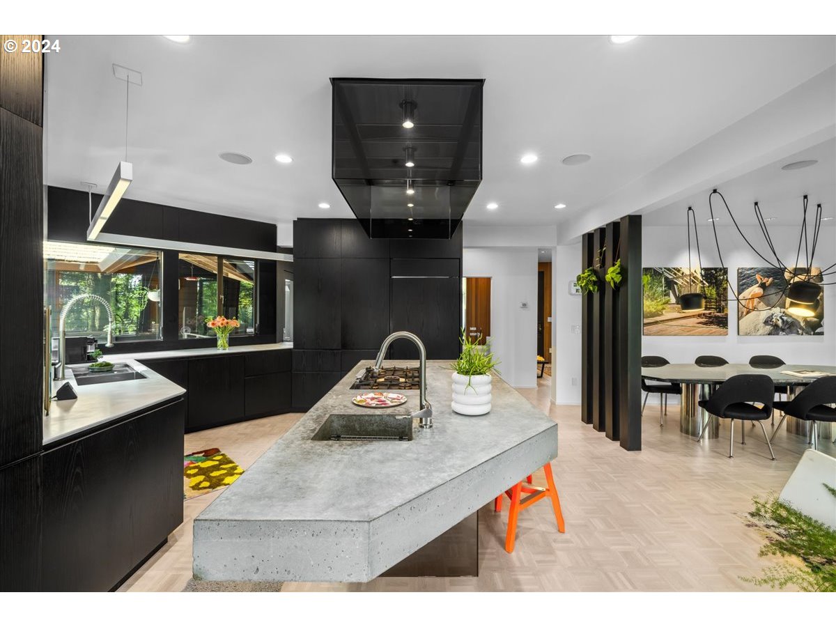 3204 Southwest Upper Cascade Drive Portland, OR 97205 - Photo 15 of 40 a kitchen with stainless steel appliances kitchen island granite countertop a sink and a refrigerator