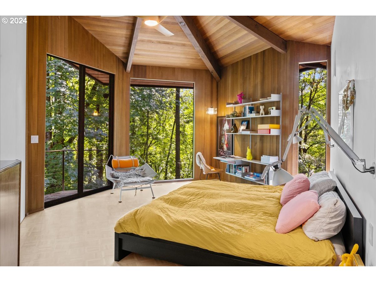 3204 Southwest Upper Cascade Drive Portland, OR 97205 - Photo 20 of 40 a bedroom with a bed wooden floor and large window