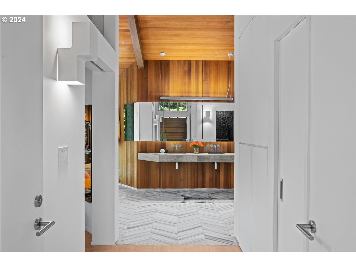 3204 Southwest Upper Cascade Drive Portland, OR 97205 - Photo 22 of 40 a view of living room with kitchen island stainless steel appliances wooden floor and living room view