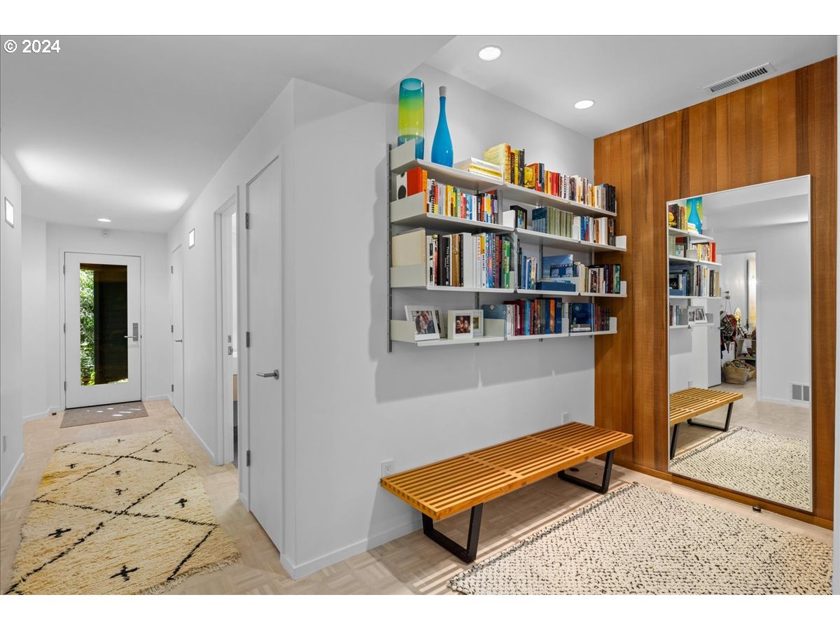 3204 Southwest Upper Cascade Drive Portland, OR 97205 - Photo 27 of 40 a living room with lots of furniture and a book shelf
