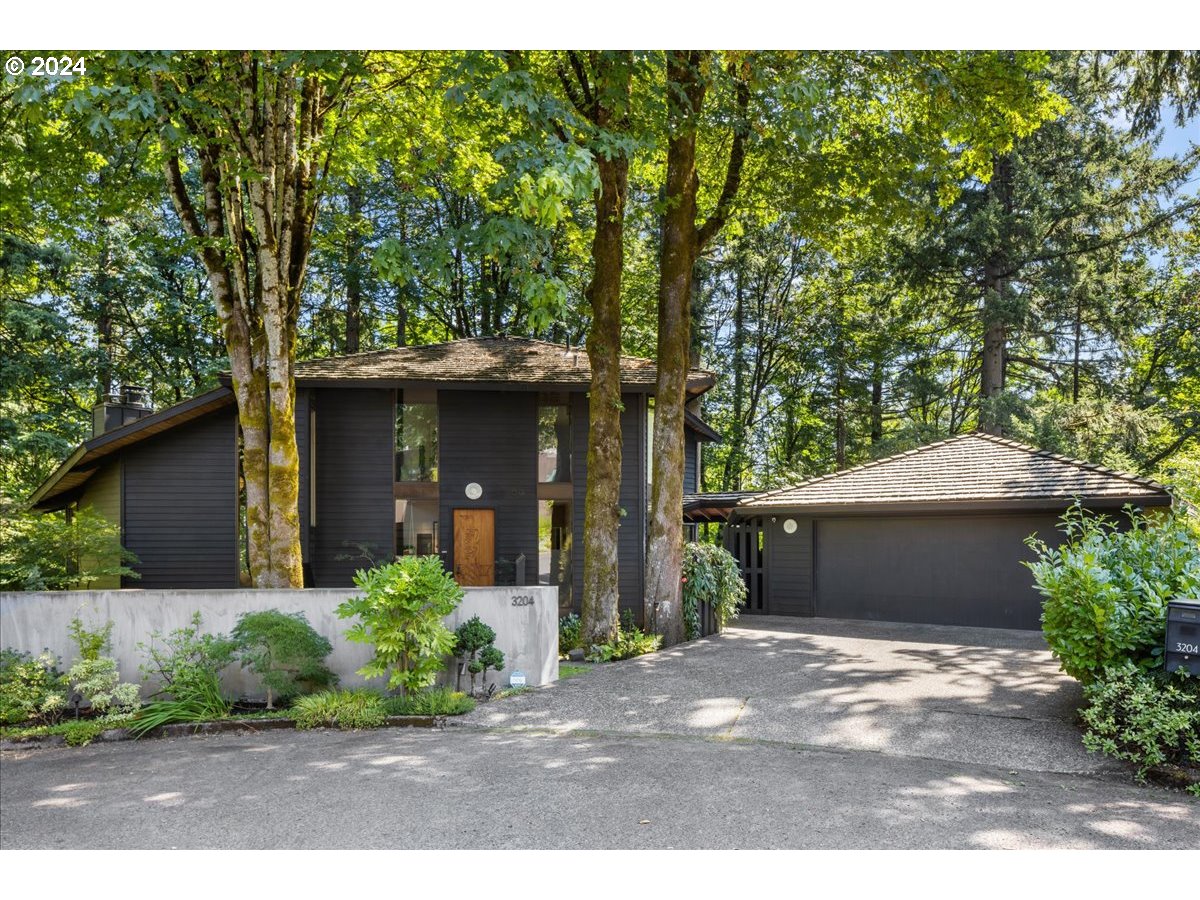 3204 Southwest Upper Cascade Drive Portland, OR 97205 - Photo 40 of 40 a front view of a house with a garden