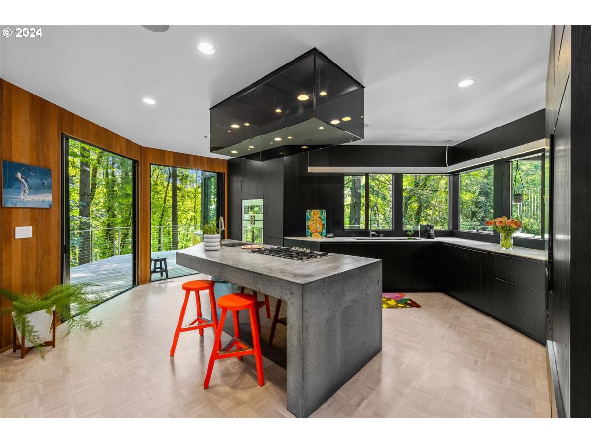3204 Southwest Upper Cascade Drive Portland, OR 97205 - Photo 9 of 40 a kitchen with stainless steel appliances granite countertop a stove and a large window