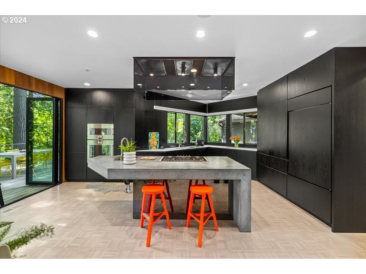 3204 Southwest Upper Cascade Drive Portland, OR 97205 - Photo 10 of 40 a kitchen with stainless steel appliances granite countertop a stove a refrigerator and a fireplace