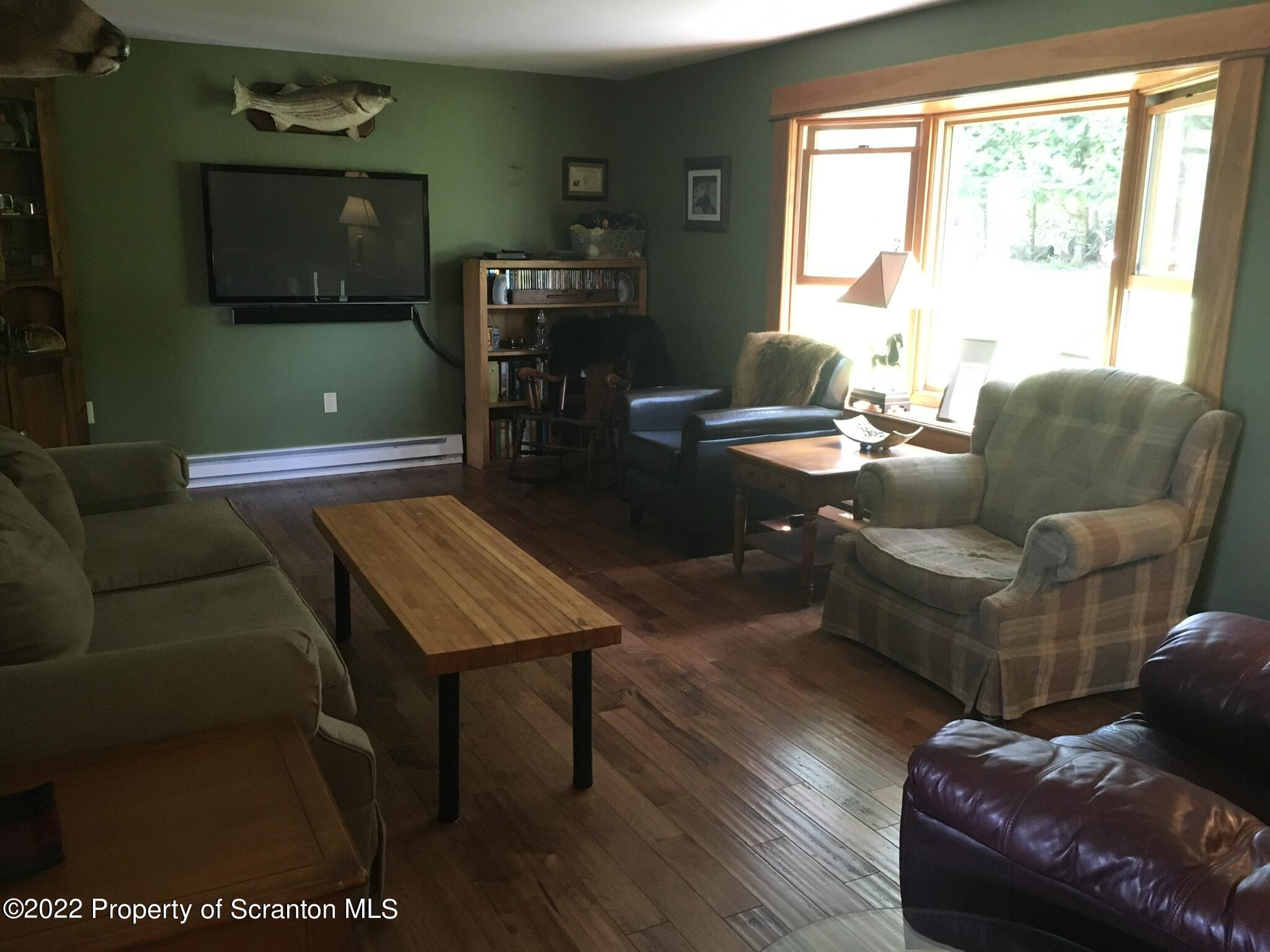 487 Baptist Hill Road Hallstead, PA 18822 - Photo 8 of 53 a living room with furniture and a window