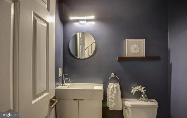 a bathroom with a toilet a sink and mirror