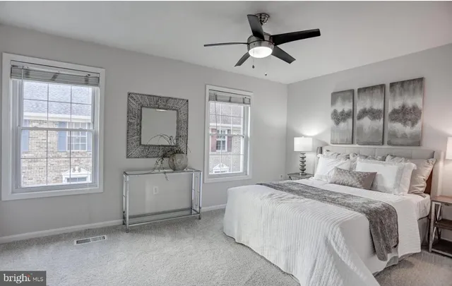 a bedroom with a bed and a large window