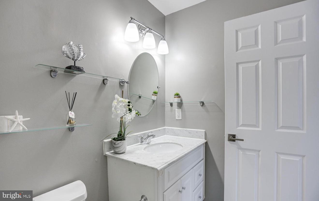 927 South Rolfe Street, Unit 2 Arlington, VA 22204 - Photo 13 of 17 a bathroom with a sink and mirror with toilet