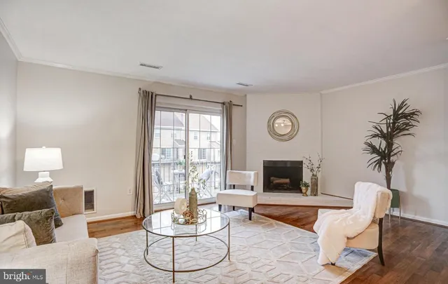 a living room with furniture a fireplace and a table