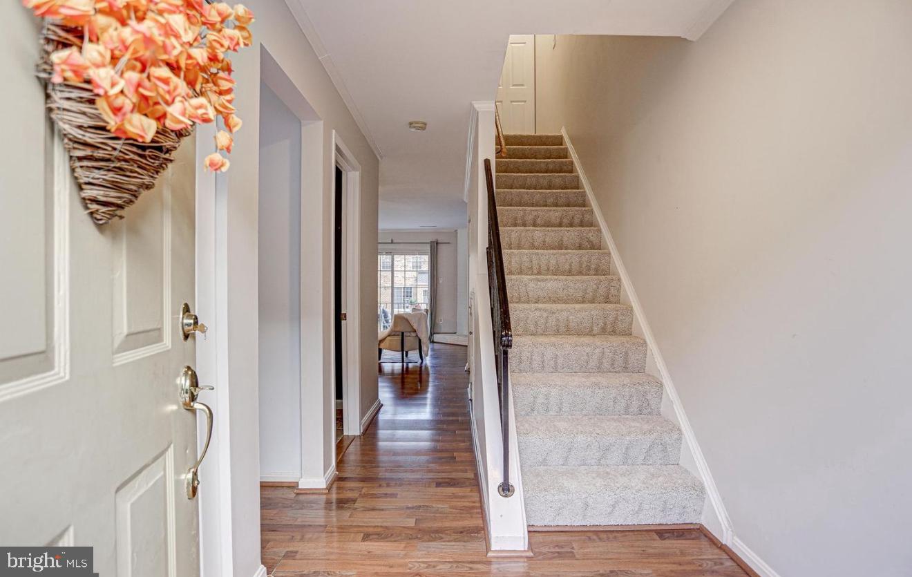 927 South Rolfe Street, Unit 2 Arlington, VA 22204 - Photo 9 of 17 a view of a hallway with wooden floor and staircase