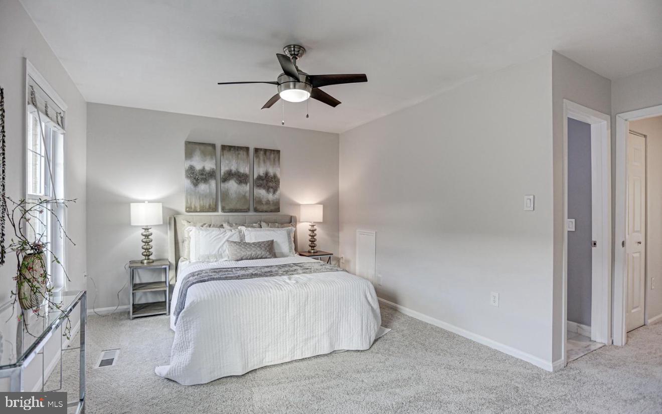927 South Rolfe Street, Unit 2 Arlington, VA 22204 - Photo 10 of 17 a bedroom with a bed and a chandelier