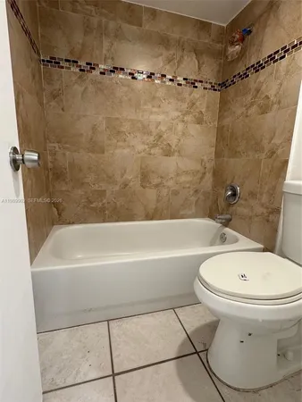 a white bath tub sitting next to a white toilet